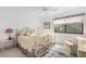 Bedroom with metal bed frame, ceiling fan, and window at 1704 Pelican Cove Rd # T138, Sarasota, FL 34231