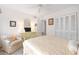 Bedroom with light colored bedding, chair, and built-in closet at 1704 Pelican Cove Rd # T138, Sarasota, FL 34231