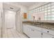 Galley kitchen with granite counters and white cabinetry at 1704 Pelican Cove Rd # T138, Sarasota, FL 34231