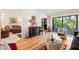 Living room with hardwood floors, comfortable seating, and access to a private patio at 1704 Pelican Cove Rd # T138, Sarasota, FL 34231
