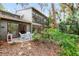 Private patio with white wicker furniture, perfect for outdoor dining at 1704 Pelican Cove Rd # T138, Sarasota, FL 34231