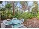 Peaceful patio setting with glass-top table and wicker chairs at 1704 Pelican Cove Rd # T138, Sarasota, FL 34231