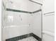 Clean shower with glass enclosure and dark green tile trim at 1704 Pelican Cove Rd # T138, Sarasota, FL 34231