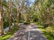 Paved walking path winding through lush tropical landscaping at 1704 Pelican Cove Rd # T138, Sarasota, FL 34231