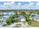 Aerial view of a modern home on a waterfront lot with paved driveway at 1739 Shelburne Ln, Sarasota, FL 34231