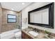 Bathroom with a tub and shower combination, granite countertop, and large mirror at 1739 Shelburne Ln, Sarasota, FL 34231