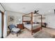 Spacious bedroom with a four-poster bed and access to a patio at 1739 Shelburne Ln, Sarasota, FL 34231