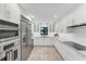 Bright white kitchen with stainless steel appliances and stylish backsplash at 1739 Shelburne Ln, Sarasota, FL 34231