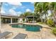 Relaxing kidney shaped pool with patio and lounge chairs at 1739 Shelburne Ln, Sarasota, FL 34231