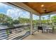 Relaxing screened balcony overlooking lush tropical landscape and waterway at 1739 Shelburne Ln, Sarasota, FL 34231