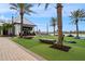 Brewery patio with cornhole, seating, and palm trees, overlooking a waterfront at 1743 Pinyon Pine Dr, Sarasota, FL 34240