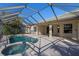 Resort-style screened pool and spa with fountain at 1743 Pinyon Pine Dr, Sarasota, FL 34240