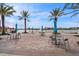 Lakeside patio with tables, chairs, and umbrellas offering scenic views at 1743 Pinyon Pine Dr, Sarasota, FL 34240