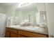 Bathroom featuring a double vanity and a shower-tub combo with white shower curtain at 1877 Dragonfly Ave, North Port, FL 34288