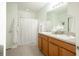 Bathroom featuring a double vanity and a shower-tub combo with white shower curtain at 1877 Dragonfly Ave, North Port, FL 34288