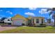 Charming single-Gathering home featuring a two-car garage, a well-kept lawn, and mature trees at 1877 Dragonfly Ave, North Port, FL 34288