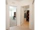 Hallway with tiled floors, leading to a bedroom with desk and full bath with shower and tub at 1877 Dragonfly Ave, North Port, FL 34288