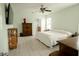 Spacious main bedroom with hardwood flooring, a ceiling fan, and a well-lit ensuite bathroom at 1877 Dragonfly Ave, North Port, FL 34288