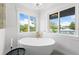 Modern bathroom with a freestanding bathtub and plenty of natural light at 2326 Gull Ln, Sarasota, FL 34237