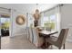 Elegant dining room featuring a rustic wood table and a beautiful chandelier at 2724 Butterfly Jasmine Trl, Sarasota, FL 34240