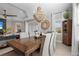 Bright dining room with a large wooden table, chandelier, and neutral decor at 2724 Butterfly Jasmine Trl, Sarasota, FL 34240