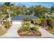 House with a large yard, circular driveway, and lush landscaping at 2961 Homasassa Rd, Sarasota, FL 34239