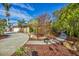 Landscaped front yard with a circular driveway and mature plants at 2961 Homasassa Rd, Sarasota, FL 34239