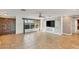 Bright living room with tile floors, built-in shelving, and large windows at 2961 Homasassa Rd, Sarasota, FL 34239