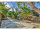 Side yard with a paved walkway and tropical landscaping at 2961 Homasassa Rd, Sarasota, FL 34239