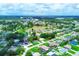Aerial view showing the community, a central lake and surrounding homes at 300 Coral Rd, Venice, FL 34293