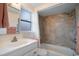 Bathroom with updated tile shower/tub combo, vanity, and window at 300 Coral Rd, Venice, FL 34293