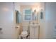 Small bathroom with toilet, sink, and linen storage at 300 Coral Rd, Venice, FL 34293