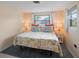 Main bedroom with king-size bed, tropical bedding, and window with natural light at 300 Coral Rd, Venice, FL 34293
