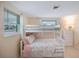 Bedroom with twin-over-full bunk bed, dresser, and window at 300 Coral Rd, Venice, FL 34293