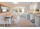 Bright dining area with table and chairs, open to kitchen and sunroom at 300 Coral Rd, Venice, FL 34293