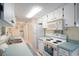 Efficient kitchen with white cabinets, ample counter space, and built-in microwave at 300 Coral Rd, Venice, FL 34293