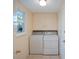 Practical laundry room with washer, dryer, and ample storage cabinets at 300 Coral Rd, Venice, FL 34293
