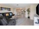 Spacious living room featuring a sectional sofa, large TV, and ample natural light at 300 Coral Rd, Venice, FL 34293