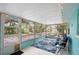 Relaxing screened porch with seating and string lights at 300 Coral Rd, Venice, FL 34293