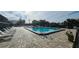 Inviting community pool with plenty of lounge chairs at 3935 Panola Ln # 183, Sarasota, FL 34232