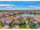 Aerial view showcasing a neighborhood with a lake at 4132 66Th E Pl, Sarasota, FL 34243