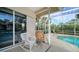 Relaxing screened-in pool area with wicker chairs at 4136 Via Mirada, Sarasota, FL 34238