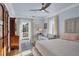 This bedroom has a ceiling fan and access to a balcony overlooking the property at 4311 Bay Shore Rd, Sarasota, FL 34234