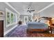 This bedroom has a ceiling fan, sitting area, and many windows for natural light at 4311 Bay Shore Rd, Sarasota, FL 34234