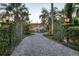 Impressive gated estate featuring a circular driveway, fountain, and meticulously landscaped grounds leading to the grand residence at 4311 Bay Shore Rd, Sarasota, FL 34234