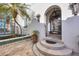 Inviting entrance with tiled flooring, potted plants, and arched doorway, creating a warm and welcoming ambiance at 4311 Bay Shore Rd, Sarasota, FL 34234