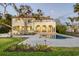 Stately waterfront home with a red tile roof, arched porch, and a refreshing swimming pool at 4311 Bay Shore Rd, Sarasota, FL 34234