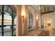 Elegant hallway featuring arched windows with water views, decorative lighting, and tiled flooring at 4311 Bay Shore Rd, Sarasota, FL 34234