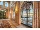Hallway featuring large arched windows, stylish curtains, and tiled flooring, offering views of the outdoor area at 4311 Bay Shore Rd, Sarasota, FL 34234