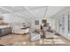 Sunlit main bedroom with tile floors, coffered ceiling, and sitting area at 4311 Bay Shore Rd, Sarasota, FL 34234